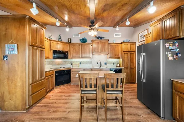 a kitchen with a refrigerator a stove top oven a sink and dishwasher