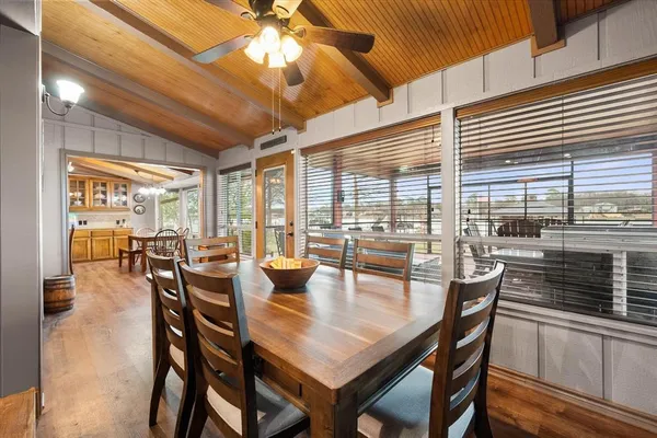 a dining room with furniture and wooden floor