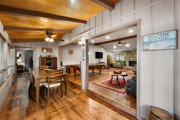 a living room with furniture and a view of kitchen