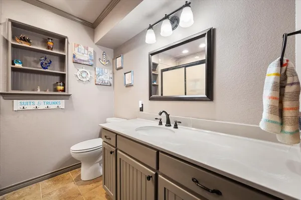 a bathroom with a toilet sink and mirror