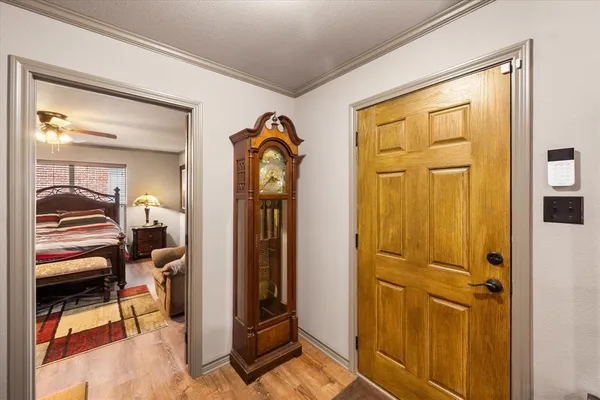 a living room with furniture a flat screen tv and a large window