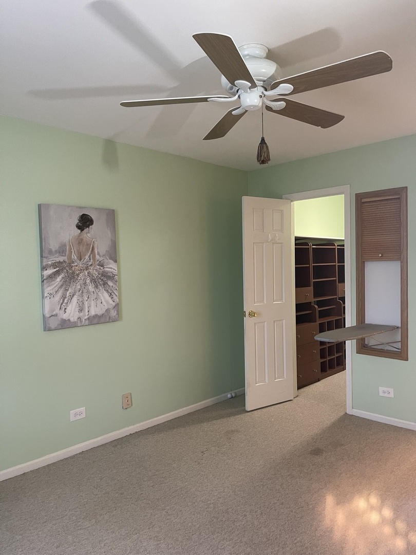 245 Memory Lane, Unit 3 Westmont, IL 60559 - Photo 14 of 28 a view of an empty room with a ceiling fan