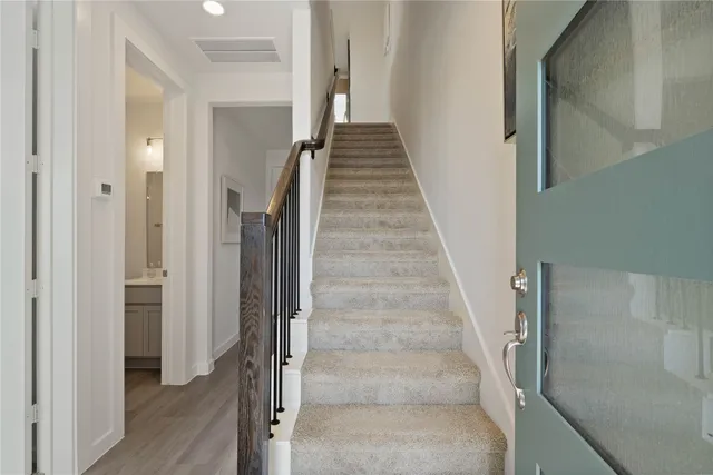 a view of entryway and gallery with wooden floor