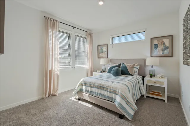 a bed sitting in a bedroom next to a window