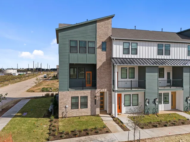 a front view of a house with a yard and lake view