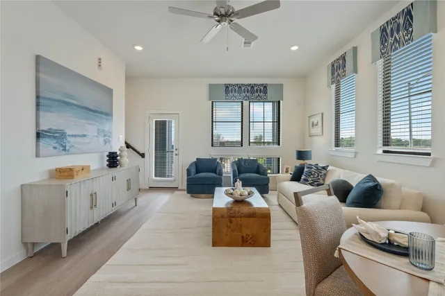 a living room with furniture and windows