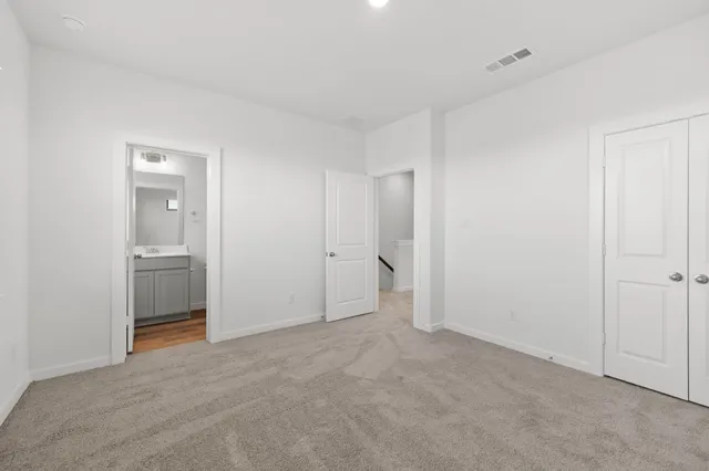 a view of an empty room with a ceiling fan