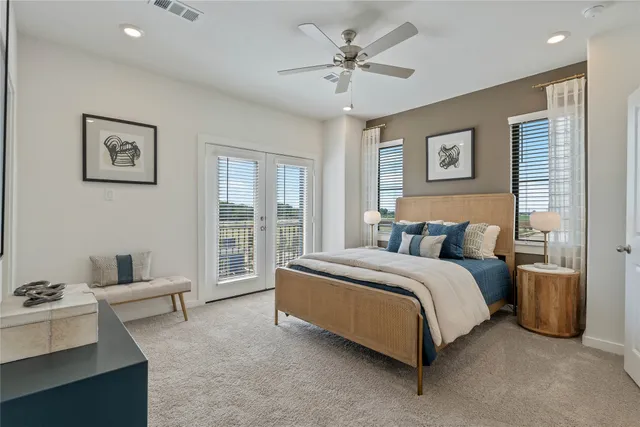 a spacious bedroom with a bed and a chandelier