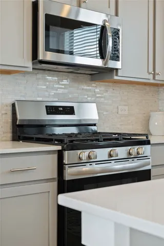 a stove top oven sitting inside of a kitchen