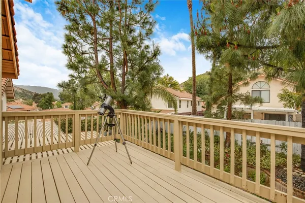 a view of balcony with wooden floor and fence