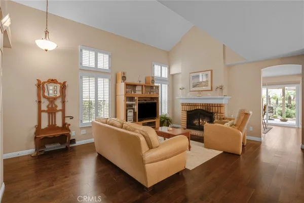 a living room with furniture a fireplace and a large window