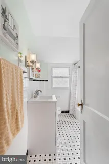 a room with a white cabinet door and a potted plant