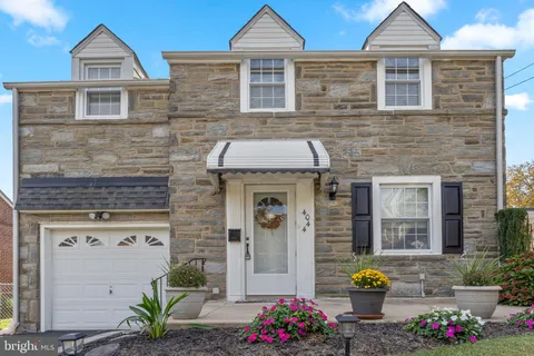a front view of a house with outdoor seating
