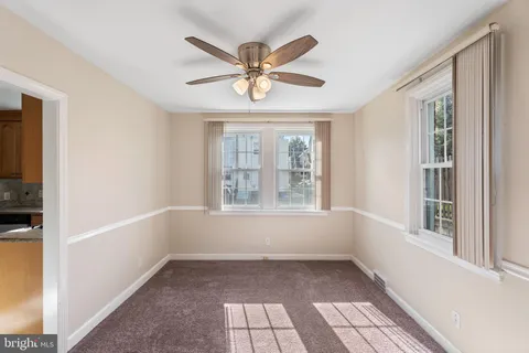a view of a livingroom with a ceiling fan and window