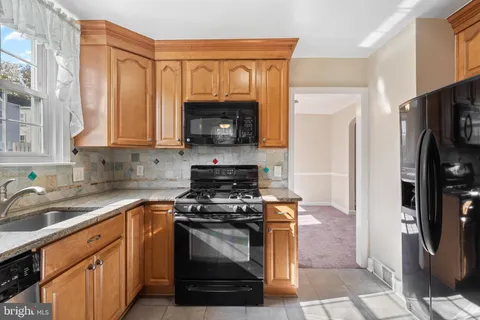 a kitchen with a stove a microwave and a refrigerator