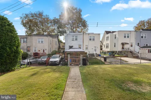 a view of a house with swimming pool and sitting area