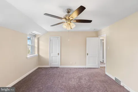 a view of a livingroom with a ceiling fan and window