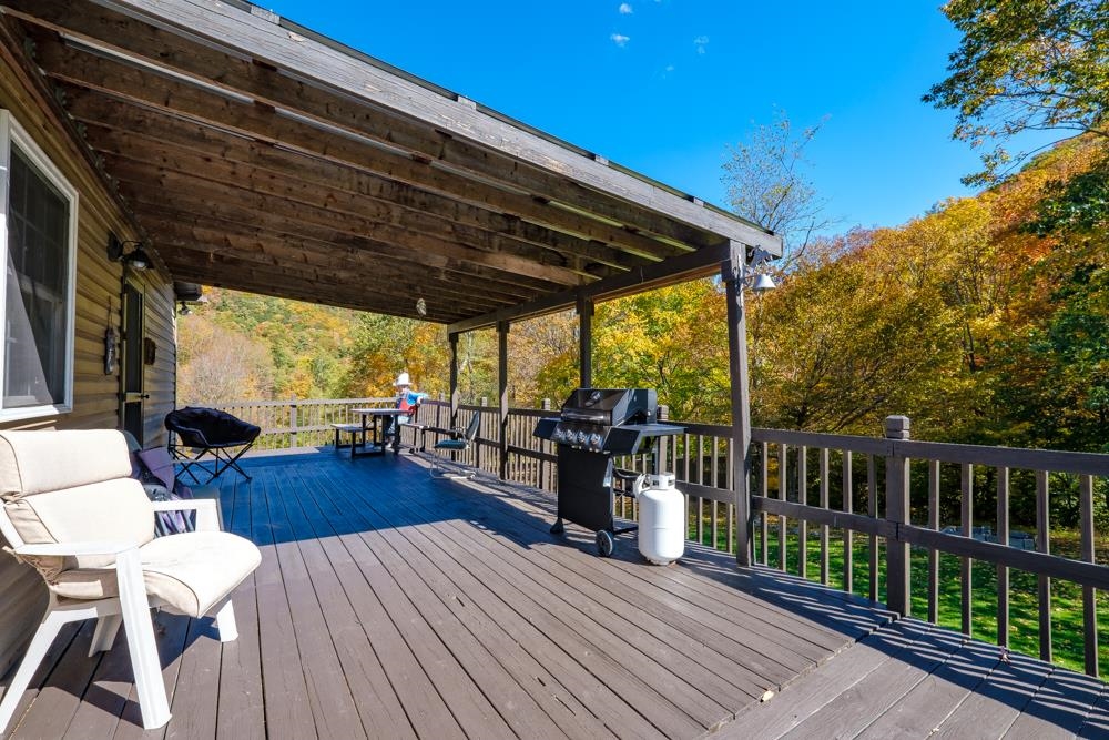 23215 Bennett Run Road Bergton, VA 22811 - Photo 3 of 19 a view of a patio with dining table and chairs with wooden floor