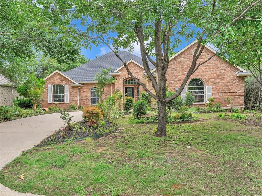 Traditional home with brick siding and a shingled roof
