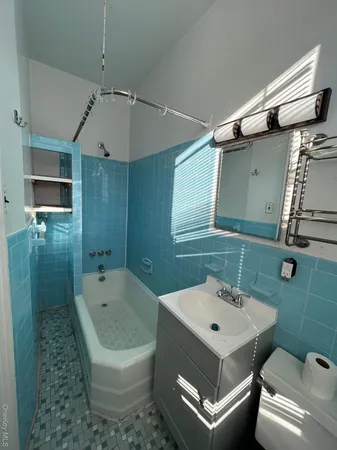 a bathroom with a toilet a sink and bathtub