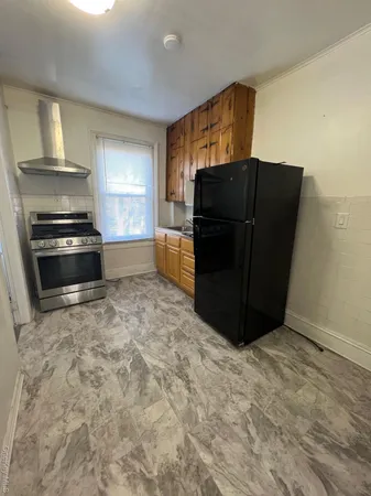 a kitchen with a refrigerator and a stove
