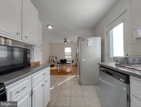 a kitchen with stainless steel appliances a stove refrigerator sink and microwave