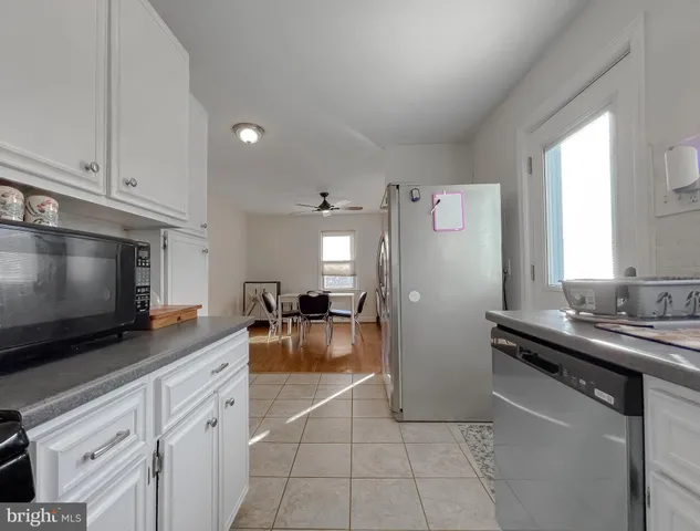 a kitchen with stainless steel appliances a stove refrigerator sink and microwave