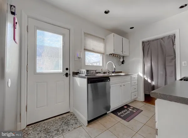 a kitchen with a refrigerator sink and cabinets