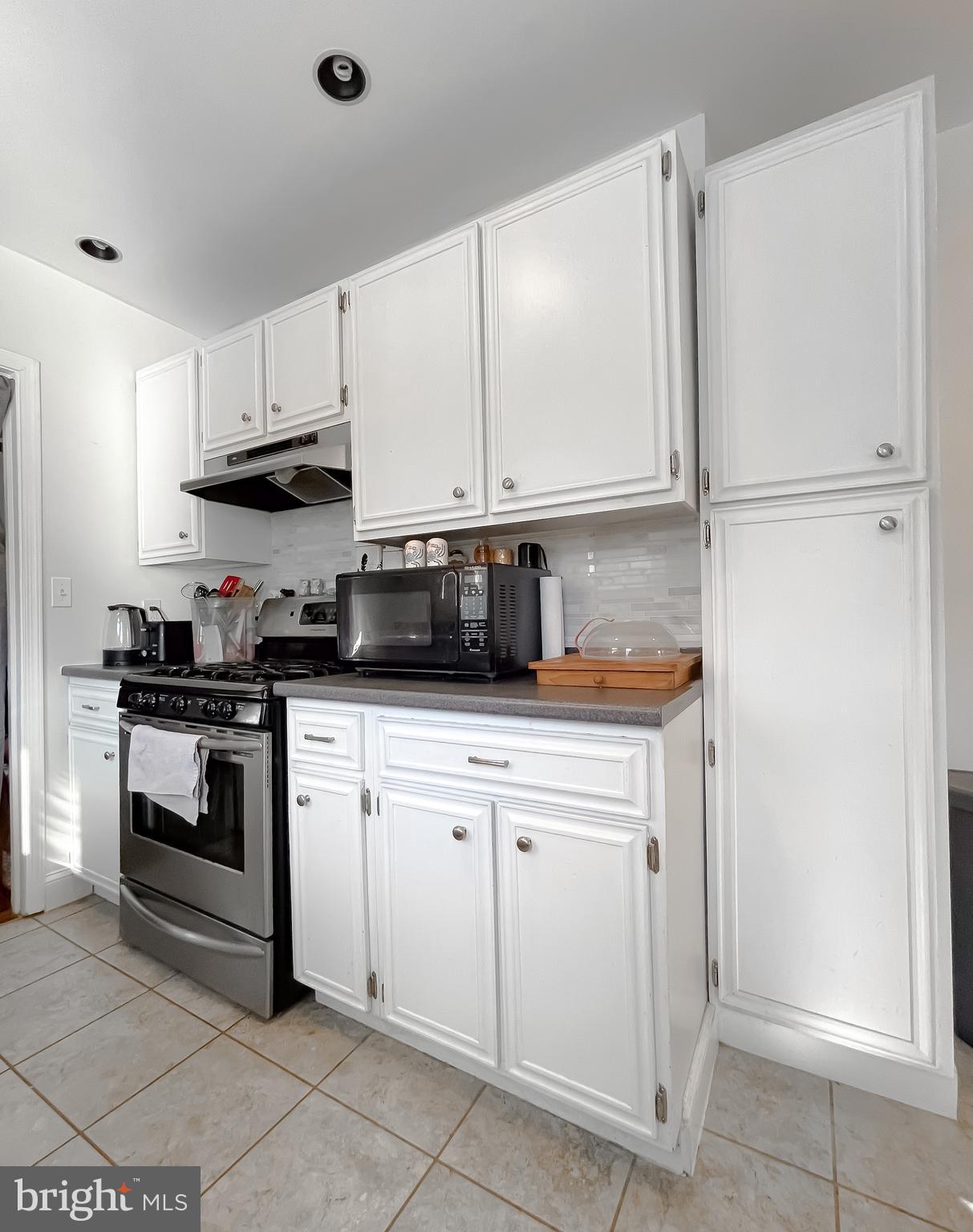 31 Governor's Gate Lane Linthicum, MD 21090 - Photo 14 of 34 a kitchen with stainless steel appliances granite countertop a refrigerator sink and cabinets
