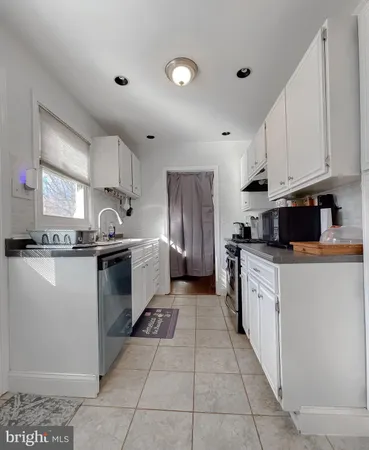 a kitchen with stainless steel appliances granite countertop a refrigerator sink and cabinets