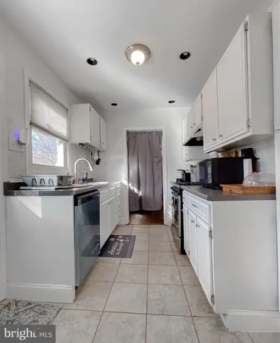 a kitchen with stainless steel appliances granite countertop a refrigerator sink and cabinets