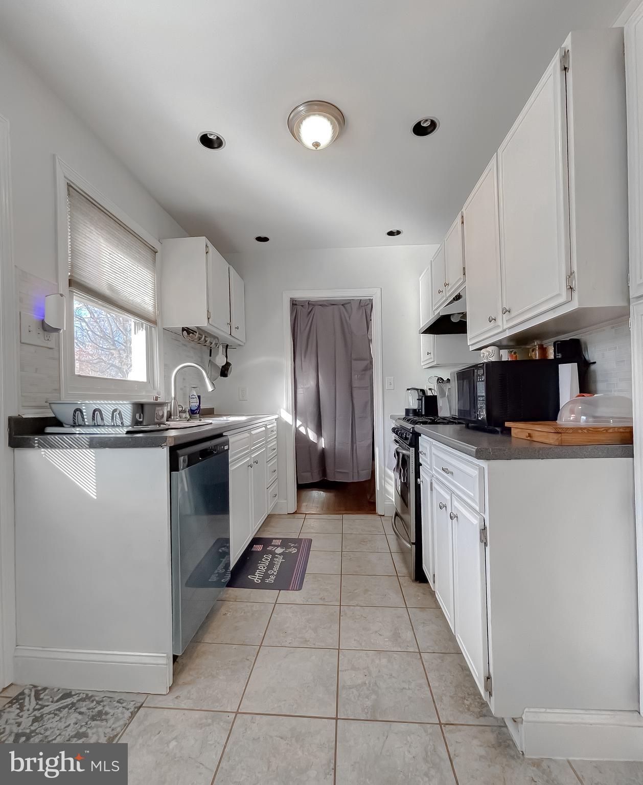 31 Governor's Gate Lane Linthicum, MD 21090 - Photo 15 of 34 a kitchen with stainless steel appliances granite countertop a refrigerator sink and cabinets