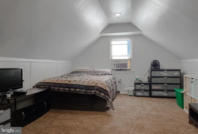 a bedroom with a bed and a television