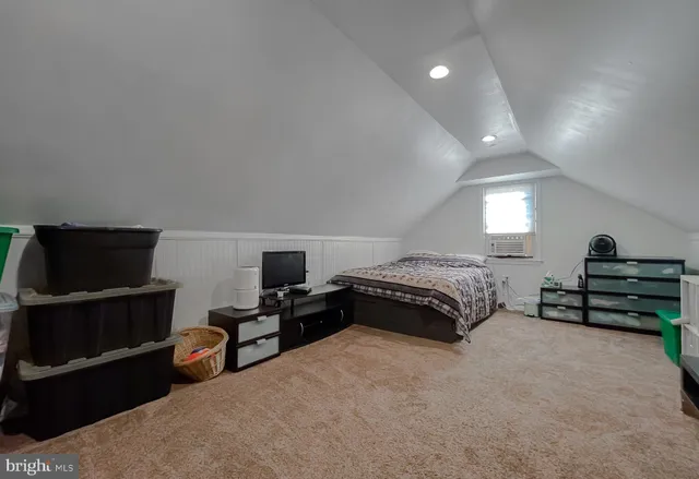 a living room with furniture a flat screen tv and a lamp