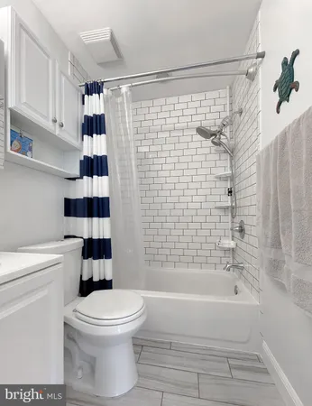 a bathroom with a toilet and shower