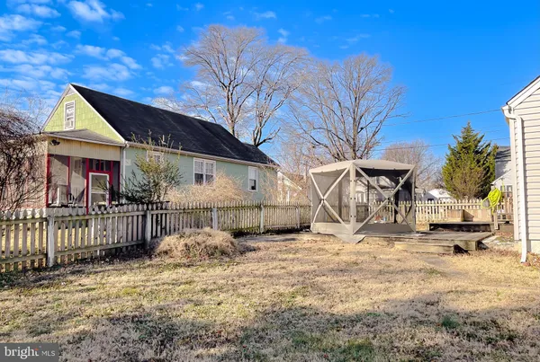 a view of a house with wooden fence