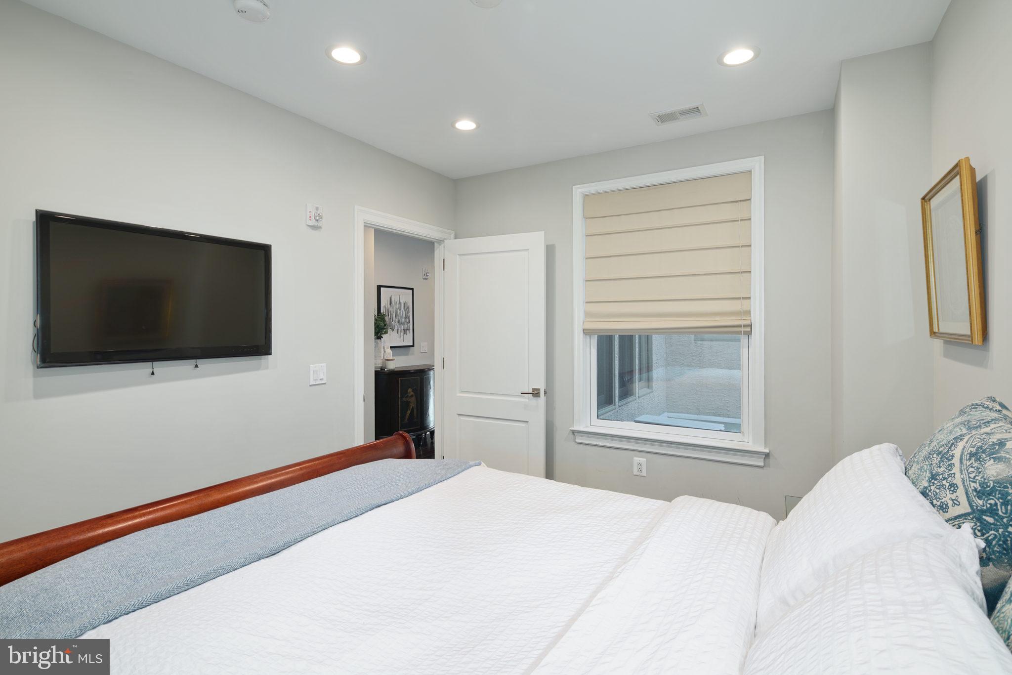 1910 Spring Garden Street, Unit 2 Philadelphia, PA 19130 - Photo 17 of 36 a bedroom with a bed and a flat screen tv
