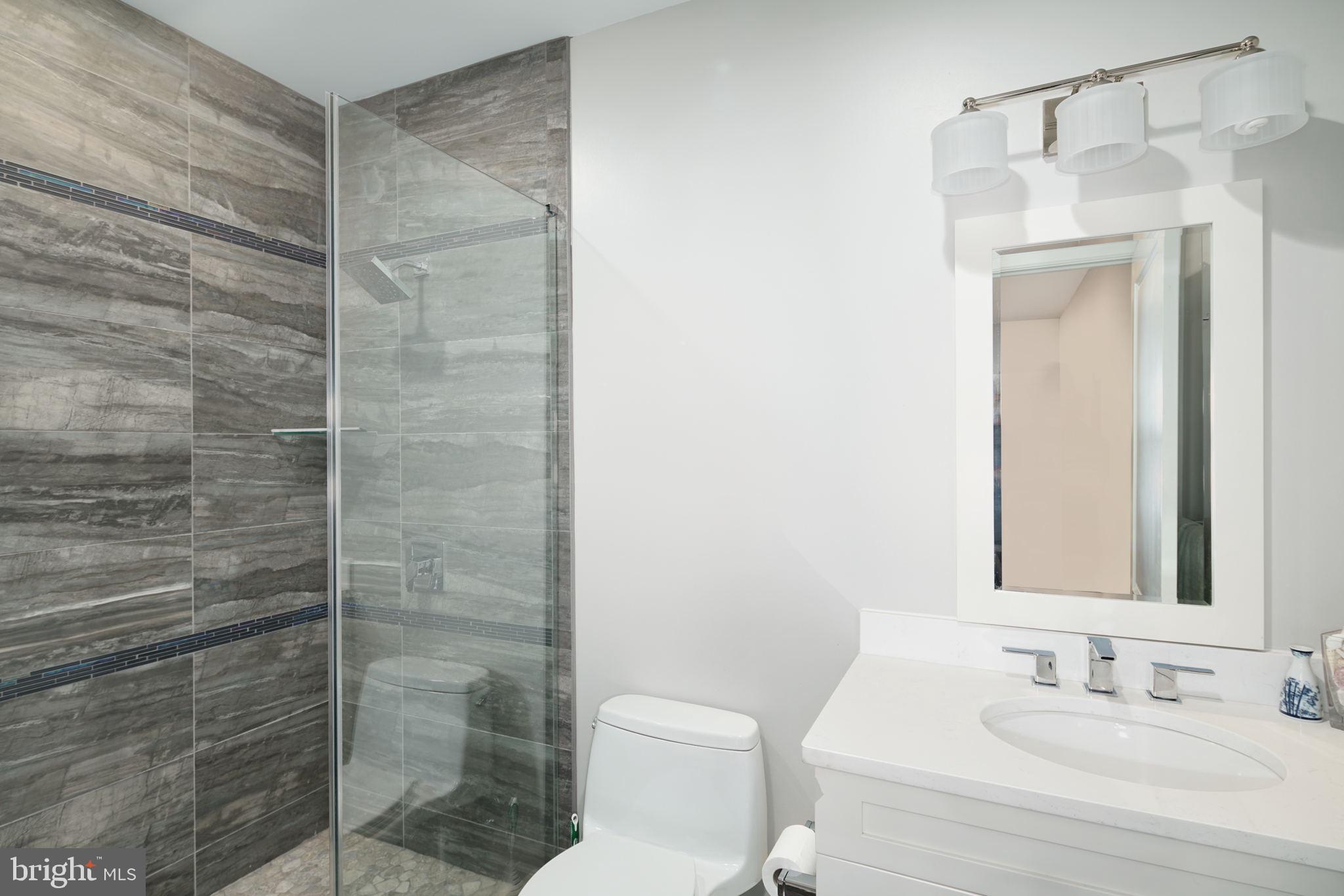 1910 Spring Garden Street, Unit 2 Philadelphia, PA 19130 - Photo 19 of 36 a bathroom with a shower a toilet and a sink