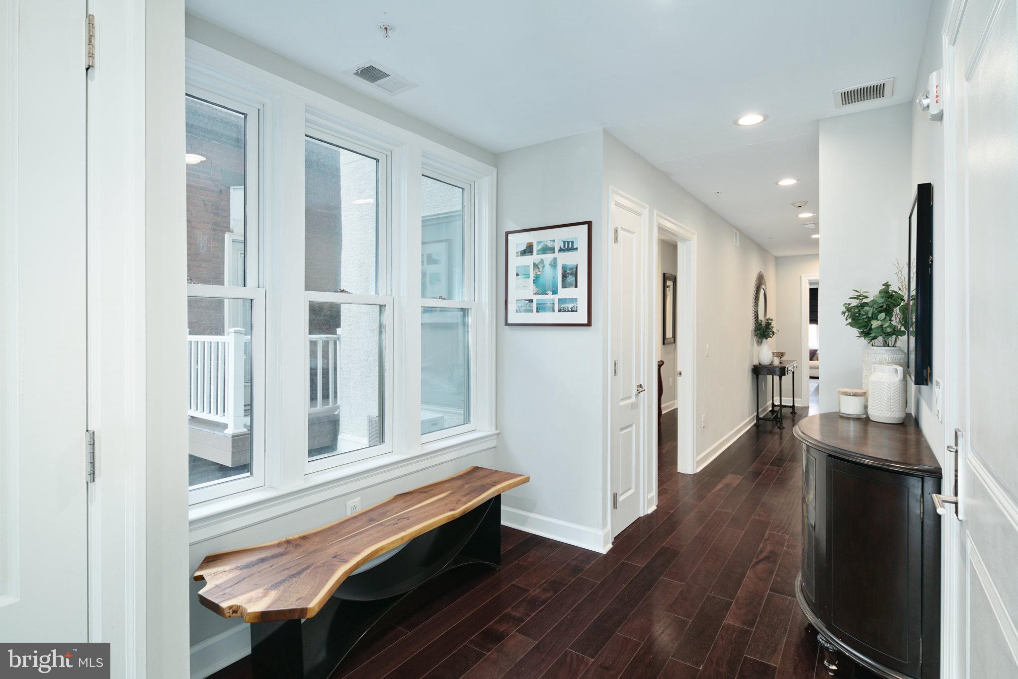 1910 Spring Garden Street, Unit 2 Philadelphia, PA 19130 - Photo 20 of 36 a view of a hallway with wooden floor and furniture