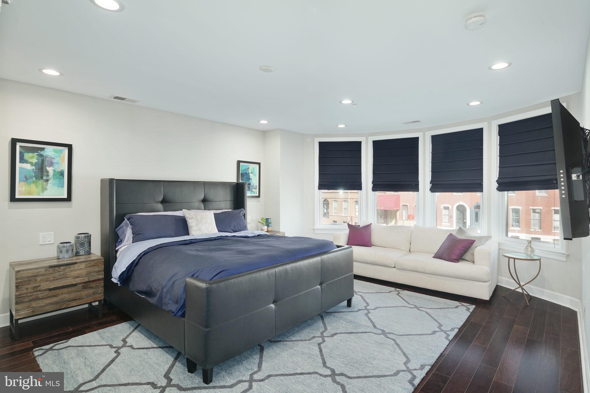 1910 Spring Garden Street, Unit 2 Philadelphia, PA 19130 - Photo 21 of 36 a bedroom with a bed a couch and window