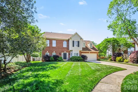 a front view of house with yard and green space