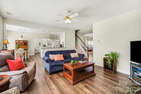 a living room with furniture a couch and a chandelier