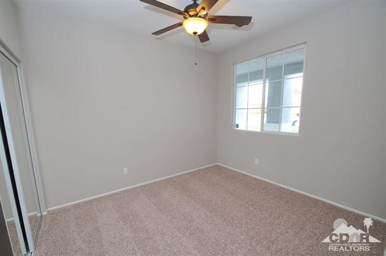 47534 Stampede Trail Indio, CA 92201 - Photo 12 of 17 an empty room with windows and fan