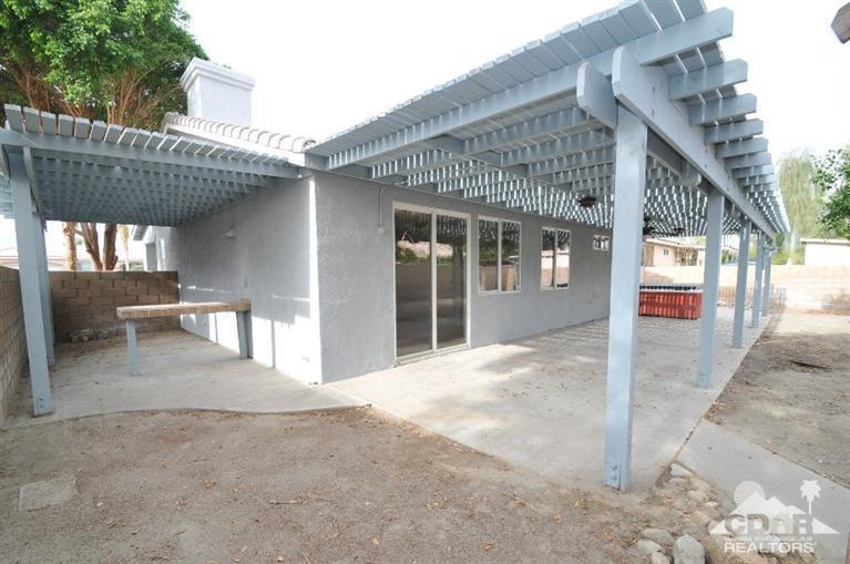 47534 Stampede Trail Indio, CA 92201 - Photo 15 of 17 a view of a house with backyard and porch