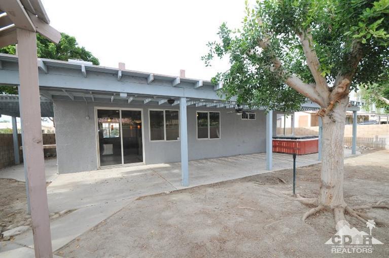 47534 Stampede Trail Indio, CA 92201 - Photo 16 of 17 a view of a house with a tree and front view of a house