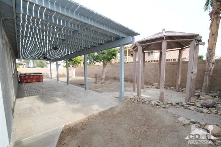 47534 Stampede Trail Indio, CA 92201 - Photo 17 of 17 a backyard of a house with table and chairs