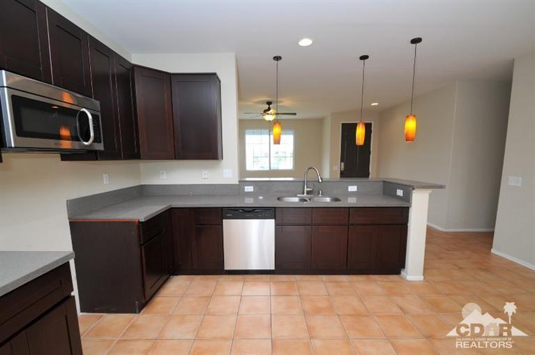 47534 Stampede Trail Indio, CA 92201 - Photo 5 of 17 a kitchen with a sink and cabinets