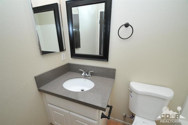 47534 Stampede Trail Indio, CA 92201 - Photo 6 of 17 a bathroom with a toilet sink and mirror