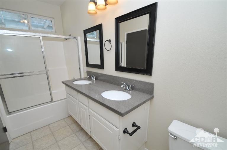 47534 Stampede Trail Indio, CA 92201 - Photo 9 of 17 a bathroom with a sink a toilet and mirror