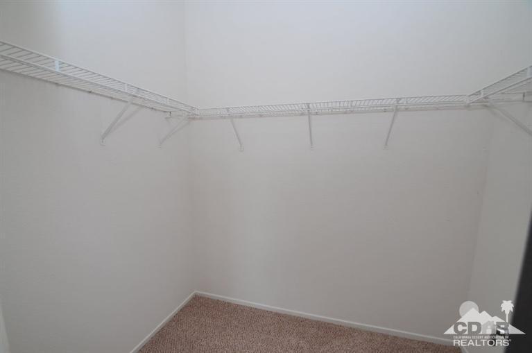 47534 Stampede Trail Indio, CA 92201 - Photo 10 of 17 a view of a room with racks on the wall